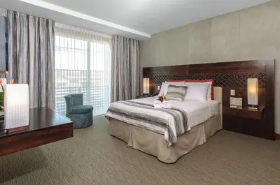 a hotel room with a large bed and a desk at Isla Verde Hotel in San José