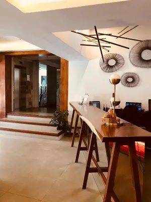 a dining room with a table and a ceiling fan at Isla Verde Hotel in San José