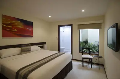 a bedroom with a large bed and a window at Isla Verde Hotel in San José