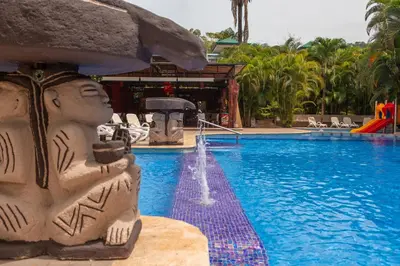 a pool at a resort with a water fountain at Leyenda Boutique Hotel & Spa in Sámara