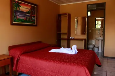 a bedroom with a bed with a swan on it at Cabinas Eddy B&B in Monteverde Costa Rica