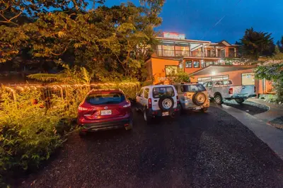 a couple of cars parked on the side of a road at Cabinas Eddy B&B in Monteverde Costa Rica
