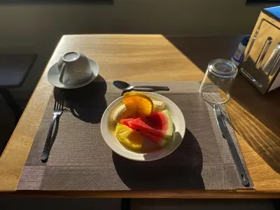 a bowl of fruit on a table with a plate of food at Cabinas Eddy B&B in Monteverde Costa Rica