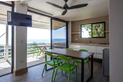 a kitchen and dining room with a table and chairs at Funky Monkey Lodge in Santa Teresa Beach
