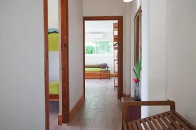 a hallway with a mirror and a couch in a room at Funky Monkey Lodge in Santa Teresa Beach