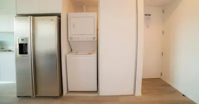 a kitchen with two refrigerators sitting next to each other at BEE Suites San José - Escalante in San José