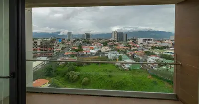 a view of a city from a window at BEE Suites San José - Escalante in San José