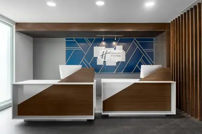 an office with two desks and a sign on the wall at Holiday Inn Express San Jose Forum by IHG in San José