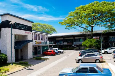 a parking lot with cars parked in front of a store at Holiday Inn Express San Jose Forum by IHG in San José