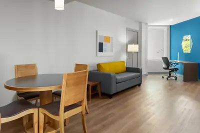 a living room with a table and a couch at Holiday Inn Express San Jose Forum by IHG in San José