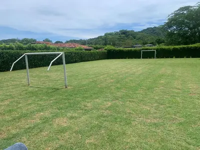 a soccer field with two goal posts in the grass at Casa vacacional Tamarindo beach in Guatemala
