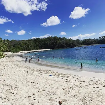 a group of people playing in the water on a beach at Casa vacacional Tamarindo beach in Guatemala