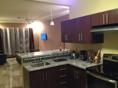 a kitchen with a sink and a counter top at Casa vacacional Tamarindo beach in Guatemala