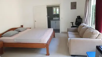 a bedroom with a large bed and a couch at Peaceful and beautiful Casa Almita Bonita in Sámara