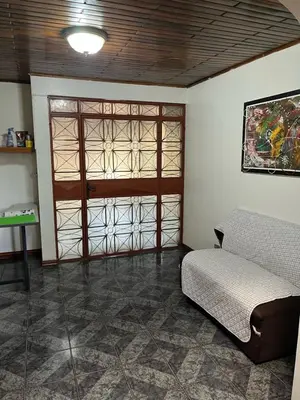 a room with a bed and a sliding glass door at El mochilero in Cartago