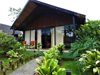 a house with glass doors and a garden at Hotel Lavas Tacotal in Fortuna