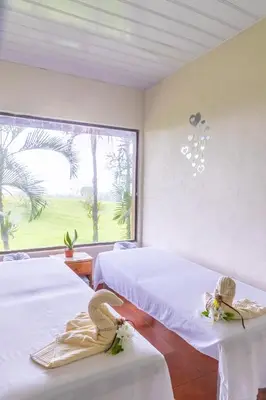 a bedroom with two beds and a large window at Hotel Lavas Tacotal in Fortuna