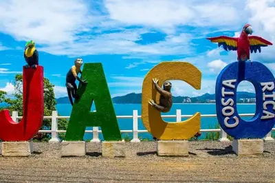 a sign with birds on it next to the water at Costa Linda 1-19, walking distance from the beach in Jacó