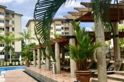 a resort with a swimming pool and palm trees at Costa Linda 1-19, walking distance from the beach in Jacó