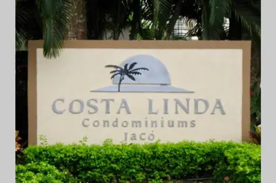 a sign for the costa lindela condominiums logo at Costa Linda 1-19, walking distance from the beach in Jacó