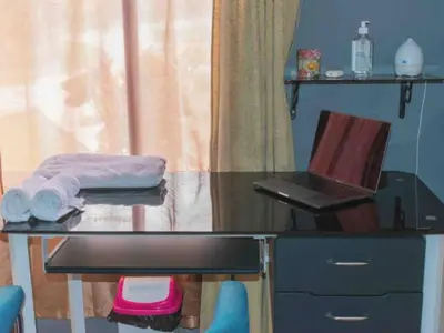 a desk with a laptop computer and a glass top at Linda casa de verano con amplias zonas verdes in San Isidro
