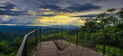 a balcony with a view of the ocean at Sunset Vista Lodge,Monteverde,Costa Rica. in Monteverde Costa Rica
