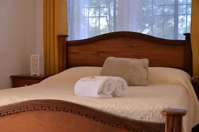 a bed with a pile of towels on it at Casa Kamagu in Fortuna