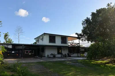 a white house with a car parked in the driveway at Casa Kamagu in Fortuna