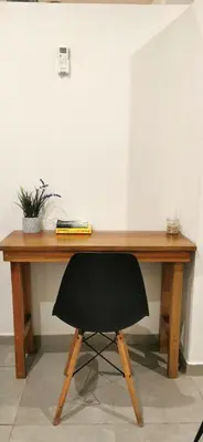 a wooden desk with a black chair in front of it at Riverside Apartments - Walk to the Beach in Santa Teresa! Newly Renovated! in Santa Teresa Beach