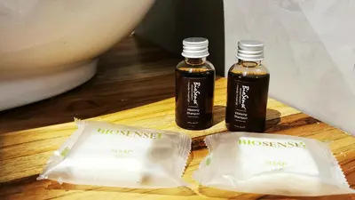 two bottles of honey sitting on a wooden table at Riverside Apartments - Walk to the Beach in Santa Teresa! Newly Renovated! in Santa Teresa Beach