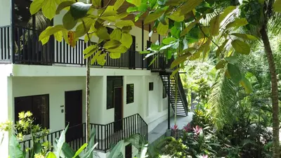 an external view of a building with plants at Riverside Apartments - Walk to the Beach in Santa Teresa! Newly Renovated! in Santa Teresa Beach