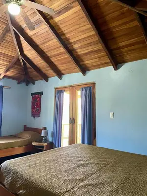 a bedroom with a bed in a room with wooden ceilings at Apartamento Boruca Tamarindo in Tamarindo