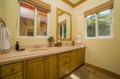 a bathroom with a sink and two mirrors at Casa Oasis 5 bdrs private pool in Los Suenos in Herradura