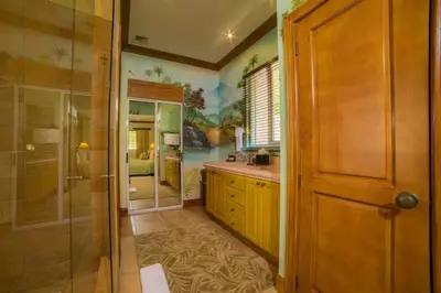 a bathroom with a shower and a sink and a glass door at Casa Oasis 5 bdrs private pool in Los Suenos in Herradura