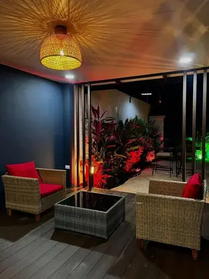 a living room with a couch and a fire pit at Mevak Apartments Suites in Fortuna