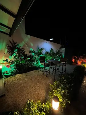 a patio with a table and chairs at night at Mevak Apartments Suites in Fortuna