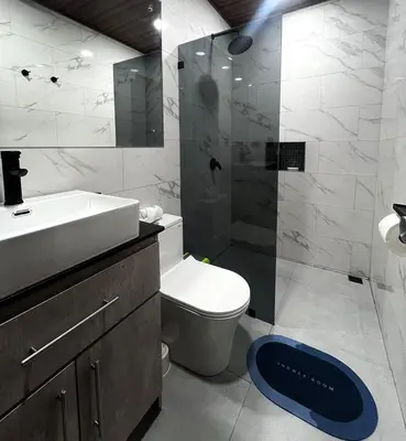 a bathroom with a toilet and a sink and a shower at Mevak Apartments Suites in Fortuna