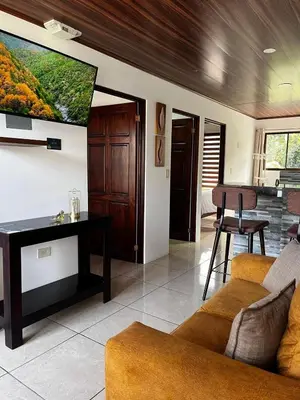 a living room with a couch and a flat screen tv at Mevak Apartments Suites in Fortuna