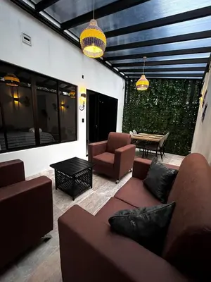 a living room with a couch and chairs and a table at Mevak Apartments Suites in Fortuna
