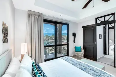 a bedroom with a bed and a large window at Beautiful and Enchanting Beach Vacation in Jacó