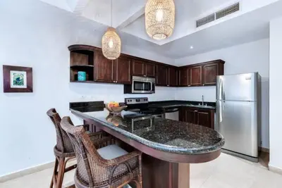 a kitchen with a counter and a refrigerator at Beautiful and Enchanting Beach Vacation in Jacó