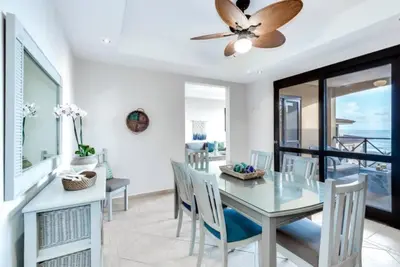 a dining room with a glass table and chairs at Beautiful and Enchanting Beach Vacation in Jacó
