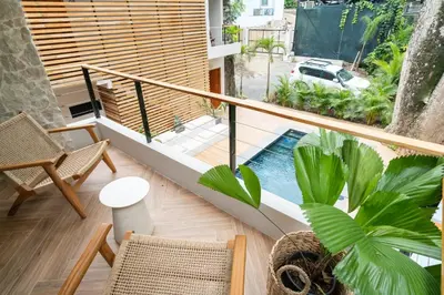 a room with a balcony with a pool and plants at Nala Luxury Living - Santa Teresa - Costa Rica in Santa Teresa Beach