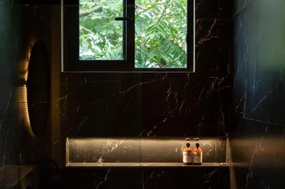 a bathroom with a window and two bottles on a shelf at Nala Luxury Living - Santa Teresa - Costa Rica in Santa Teresa Beach