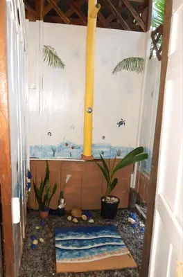 a bathroom with a toilet with plants in it at Fully Furnished FAMILY JUNGLE TENT, Latino Glamping Paquera in Paquera