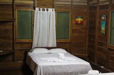 a bedroom with a bed with towels on it at Hotel La Cascada in Puntarenas