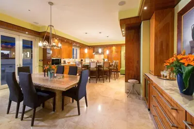 a kitchen and dining room with a table and chairs at Exquisite Hilltop Villa with Luxurious Modern Design, Sweeping Ocean Views & Sparkling Infinity Pool in Playa Flamingo