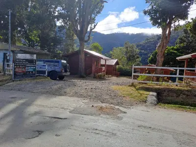 a truck parked in front of a building at Cabañas San gerardo in San Gerardo de Dota