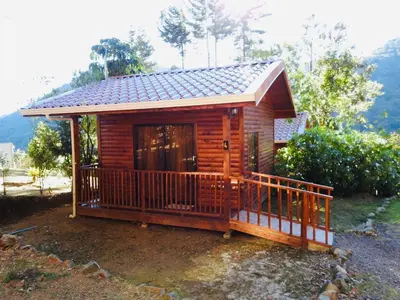 a log cabin with a porch and a deck at Cabañas San gerardo in San Gerardo de Dota