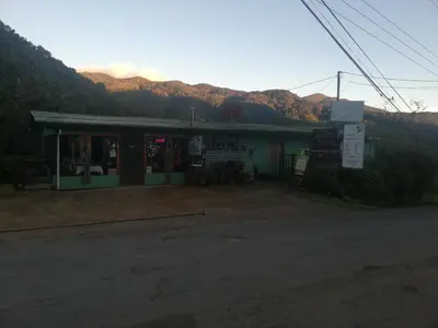 a building with a basketball hoop in front of it at Cabañas San gerardo in San Gerardo de Dota